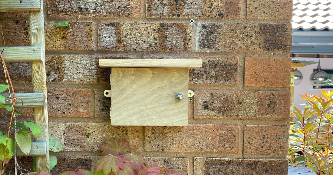 solid oak wood solitary bee house on wall in garden